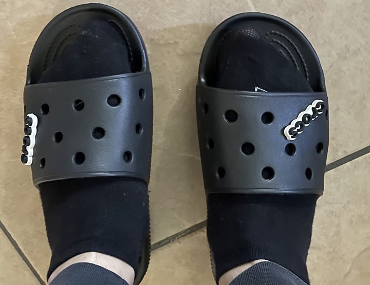 Using the black slide sandals from Crocs Classic